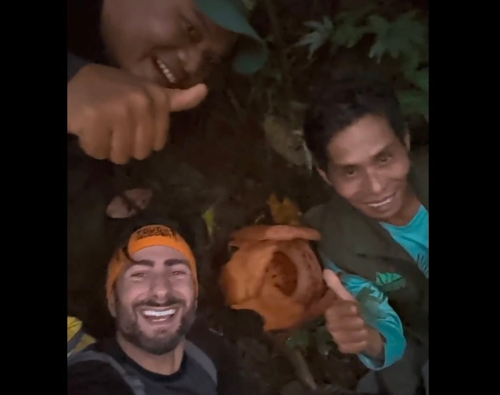 Oxford scientist Chris Thorogood and his Indonesian team members posing next to Rafflesia hasseltii, after they rediscovered the rare giant parasitic red flower in West Sumatra last month. Photo: X / University of Oxford