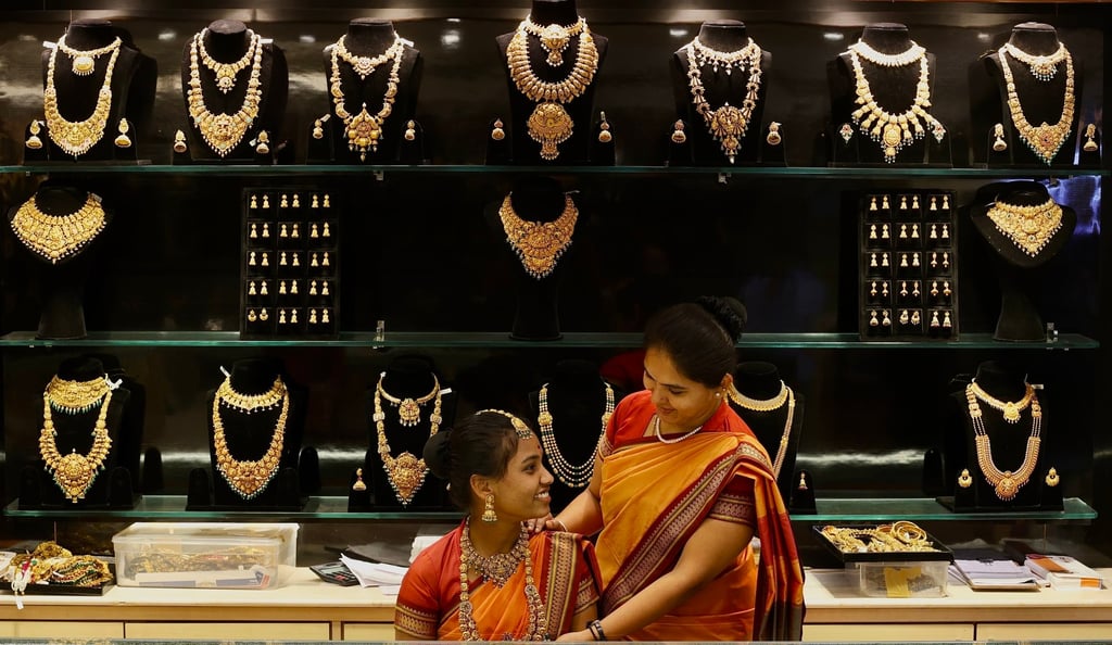 An Indian woman tries on gold ornaments at a jewellery shop in Bengaluru. India’s gem and jewellery exports rose 19.64 per cent year on year to US$2.51 billion in November. Photo: EPA