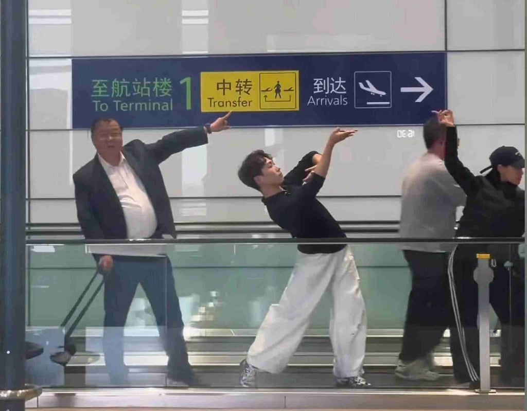 A portly Fu, far left, muscles in on the professional dance action on the airport walkway. Photo: QQ.com A portly Fu, far left, muscles in on the professional dance action on the airport walkway. Photo: QQ.com