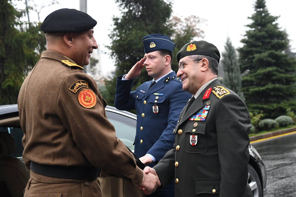 Turkish Chief of General Staff General Selcuk Bayraktaroglu (right) and Libyan Chief of General Staff General Muhammad Ali Al-Haddad shake hands in Ankara on Tuesday. Photo: Turkish Defence Ministry via AFP
