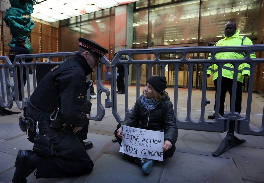 Greta Thunberg holding a sign that says she supports prisoners linked to Palestine Action. Photo: Prisoners for Palestine via Reuters