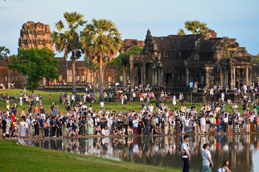 Visitors watch the sunrise at Angkor Wat in Cambodia. Photo: David Swanson