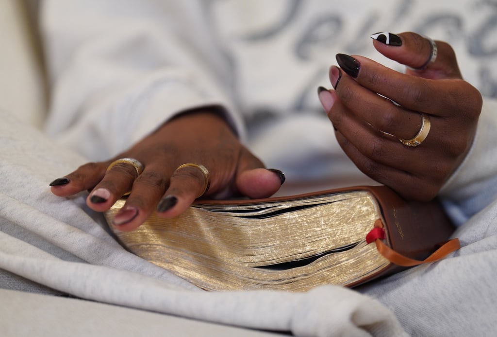 Megan Ashley, founder of Christian podcast In Totality, sits with a Bible at her home. Photo: AP