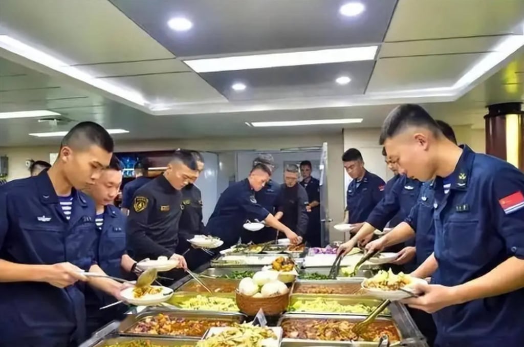 Hungry sailors tuck in to a buffet on board the aircraft carrier. Photo: Sohu