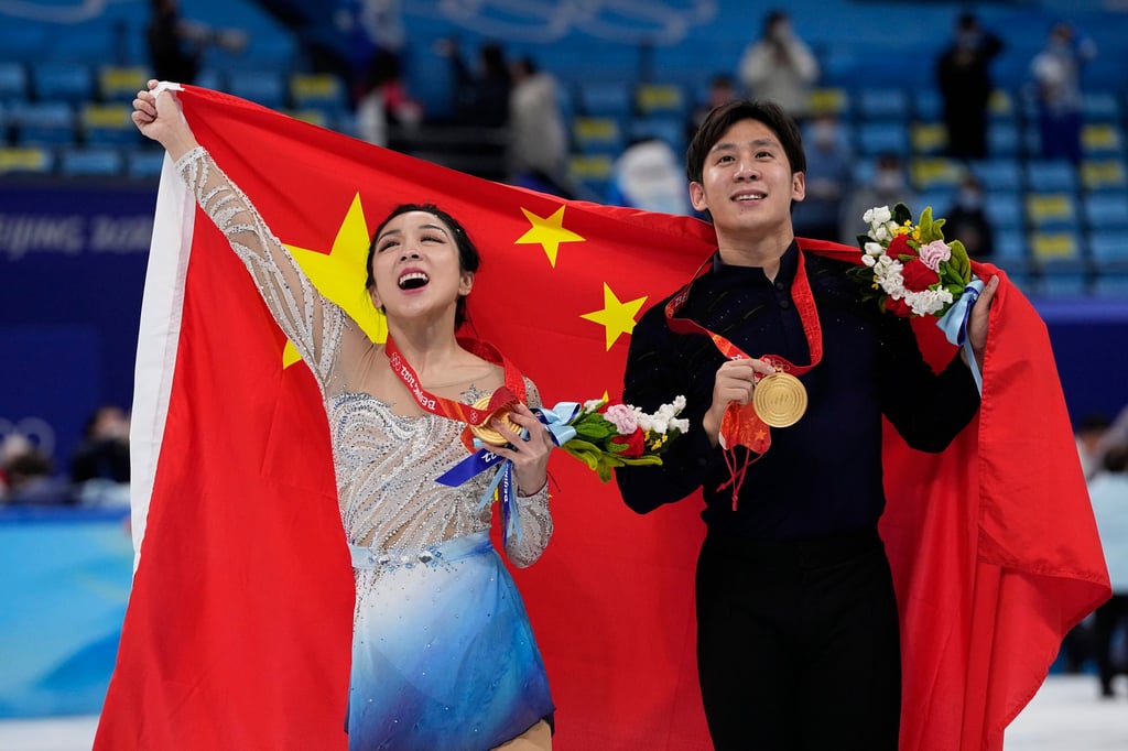 Sui Wenjing (left) and Han Cong after winning gold at the 2022 Winter Olympics in Beijing. Photo: AP