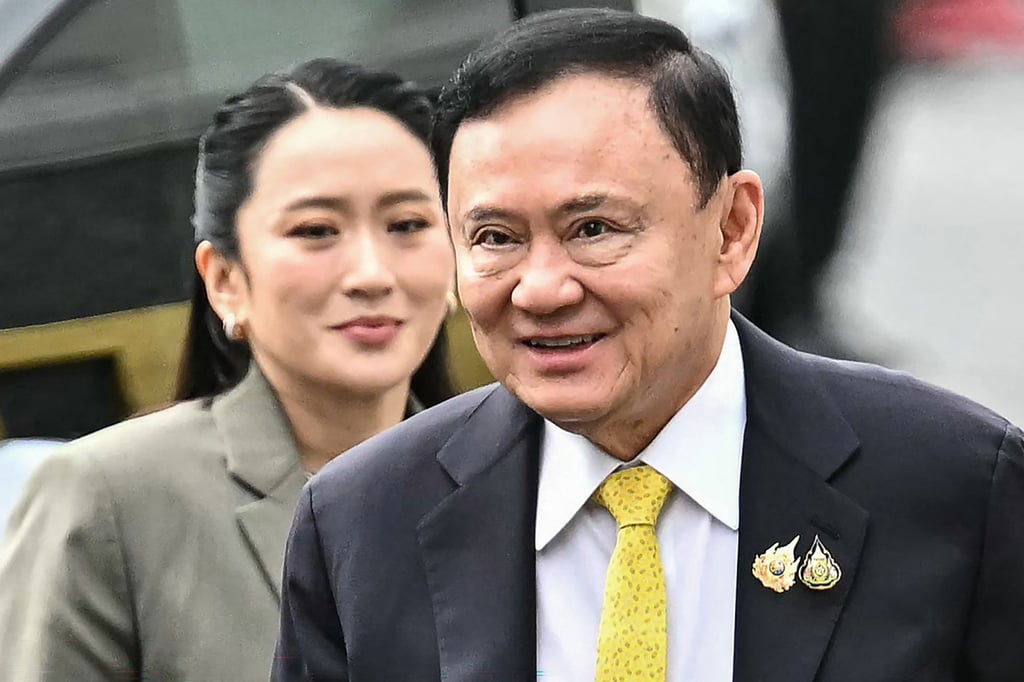 Former Thai PM Thaksin Shinawatra (right) arrives with his daughter, ex-PM Paetongtarn Shinawatra, at the Supreme Court in Bangkok in September. Photo: TNS