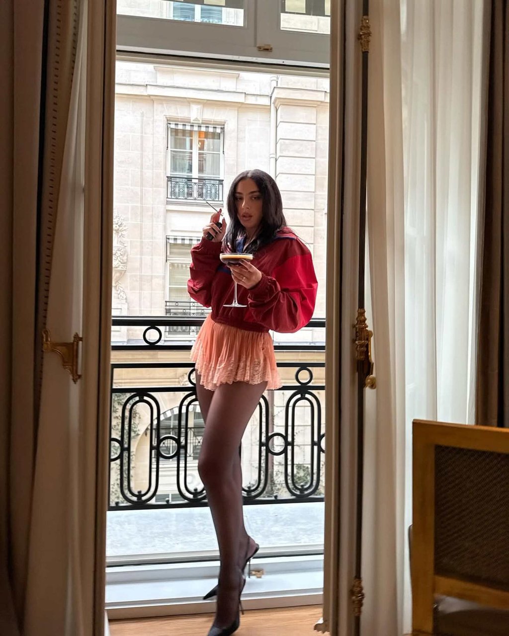 Charli XCX wearing YSL and holding a cigarette in September 2025. Photo: @charli_xcx/Instagram.