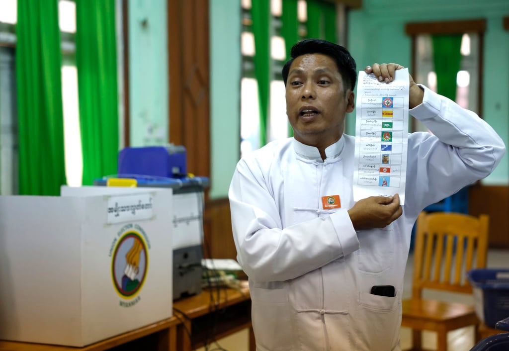 A Myanmar electoral officer counts early voting ballots after closing the first phase of the general election at a polling station in Naypyidaw on Sunday. Photo: EPA