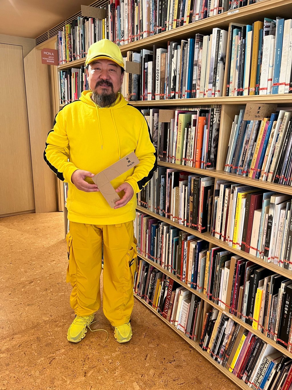 Artist Song Dong with one of his 600 bookmarks in the Asia Art Archive library. The project “600 Marks” marks the Hong Kong organisation’s 25th anniversary. Photo: Enid Tsui