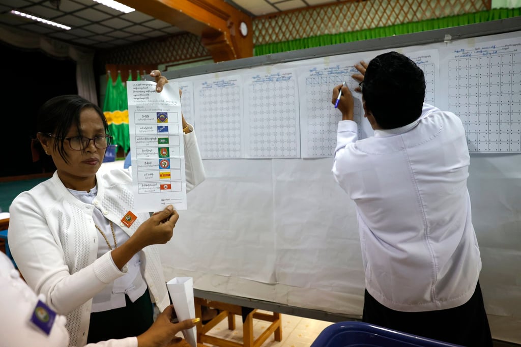 Myanmar electoral officers count early voting ballots after closing the first phase of the general election at a polling station in the capital Naypyidaw on Sunday. Photo: EPA