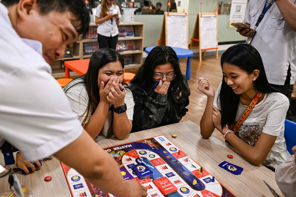 A board game educates Filipino youth in Manila on disaster readiness, enhancing skills amid frequent typhoons and earthquakes. Photo: AFP