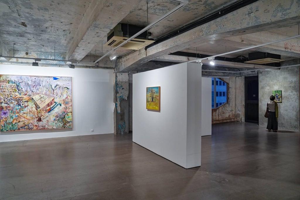 A visitor takes in one of Un Cheng’s pieces at her solo exhibition Bedroom Paintings, at Blindspot Gallery. Photo: Elson Li