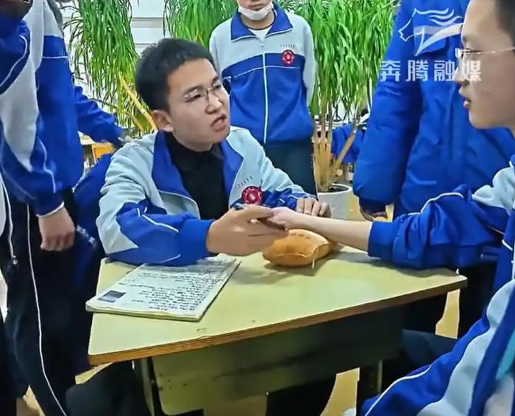 Zhao Tianyu, sitting left, shows professional attentiveness as he diagnoses a classmate. Photo: Baidu