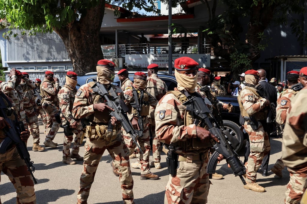 Soldiers surround Guinean leader Mamadi Doumbouya’s car as he arrives to vote on Sunday. Photo: Reuters