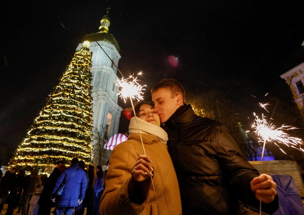 A couple kiss during a New Year celebrations in Kyiv, Ukraine. Photo: Reuters A couple kiss during a New Year celebrations in Kyiv, Ukraine. Photo: Reuters