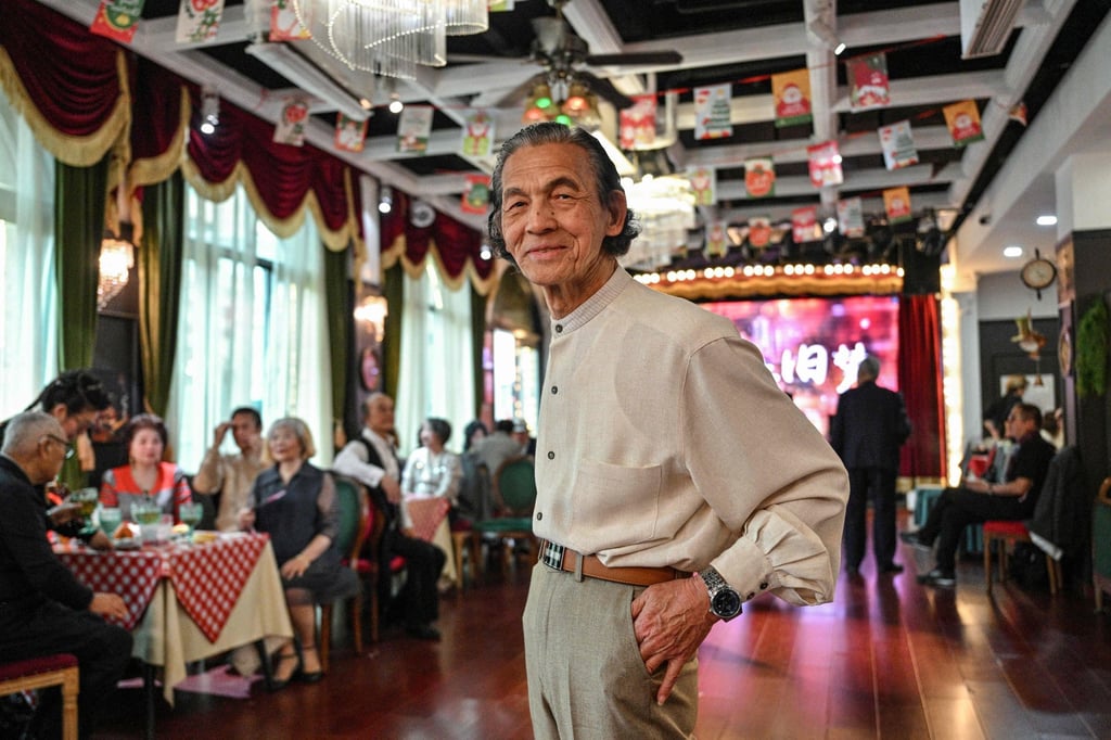 An elderly man poses for a picture at the Hai Shang Jiu Meng Dance Hall in Shanghai. For the elderly, dance halls are gyms, entertainment venues and social clubs rolled into one. Photo: AFP An elderly man poses for a picture at the Hai Shang Jiu Meng Dance Hall in Shanghai. For the elderly, dance halls are gyms, entertainment venues and social clubs rolled into one. Photo: AFP