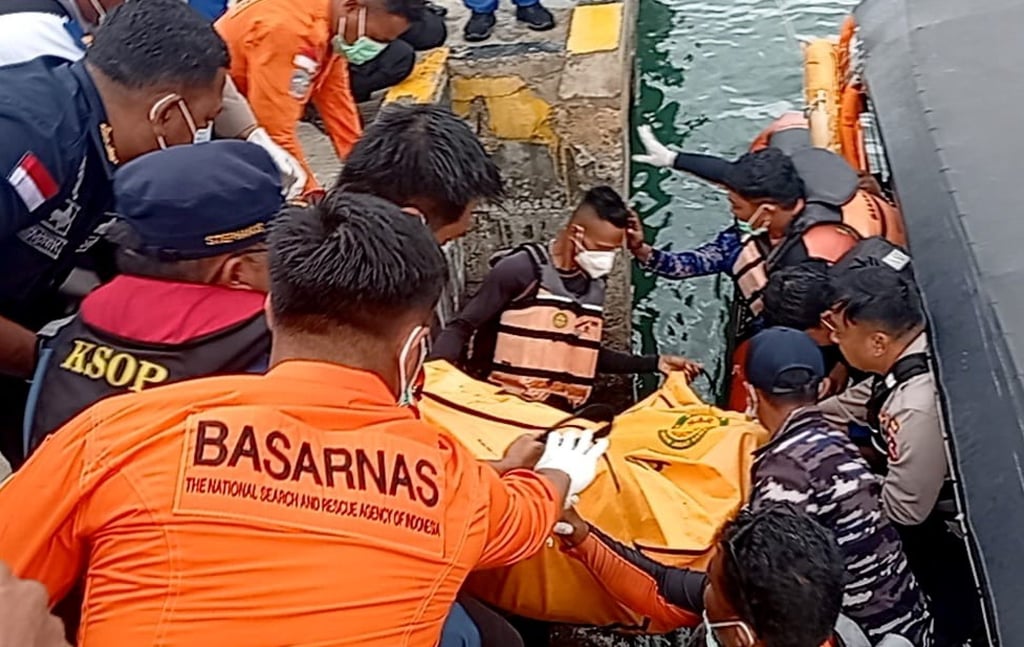 Na segunda-feira, equipas de resgate indonésias recuperaram o corpo de uma vítima num cais em Laban Bajo. Foto: EPA Na segunda-feira, equipas de resgate indonésias recuperaram o corpo de uma vítima num cais em Laban Bajo. Foto: EPA