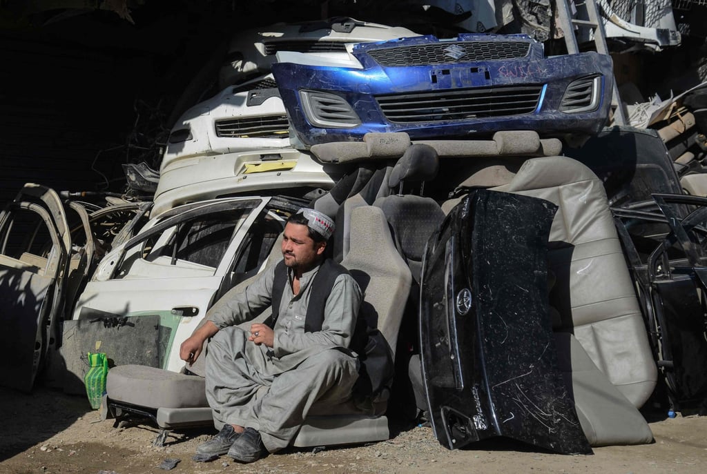 A man sits outside an auto parts shop at a market near the Afghanistan-Pakistan border in Spin Boldak. Photo: AFP A man sits outside an auto parts shop at a market near the Afghanistan-Pakistan border in Spin Boldak. Photo: AFP