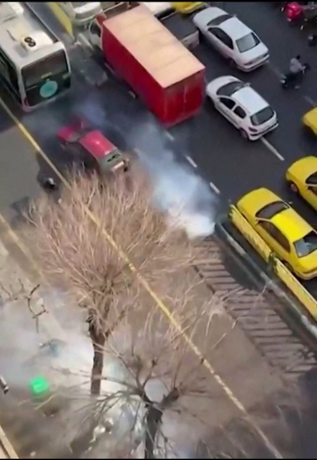 Iranian security forces dispersing protesters with tear gas in central Tehran, in an image posted online on January 4. Photo: UGC via AFP