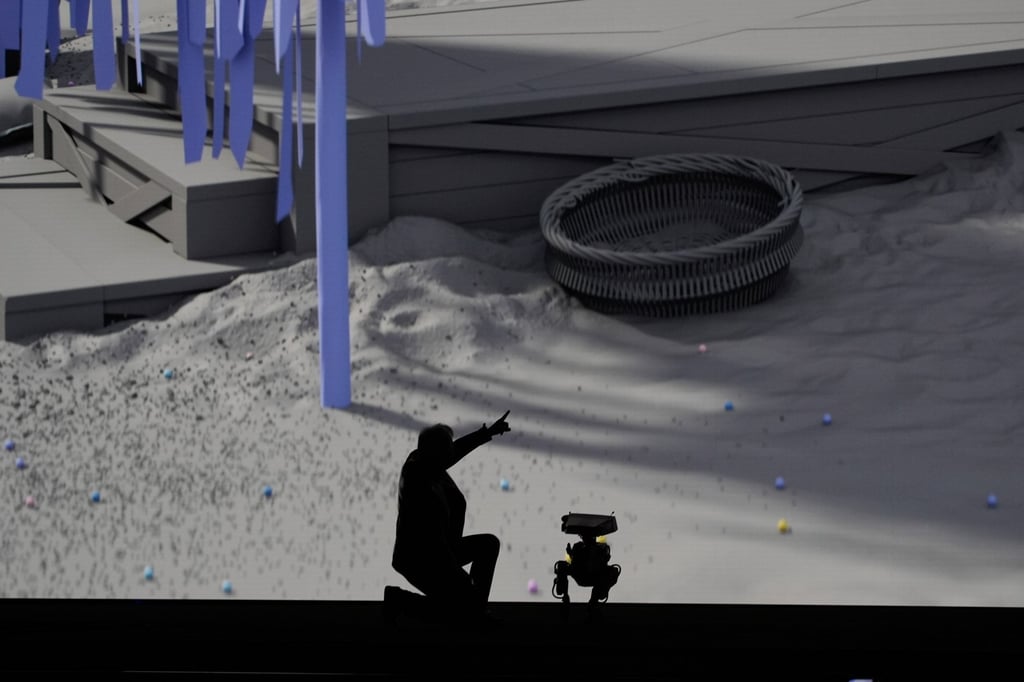 Nvidia CEO Jensen Huang kneels on stage with a robot during a Nvidia news conference ahead of the CES tech show on Monday, in Las Vegas. Photo: AP