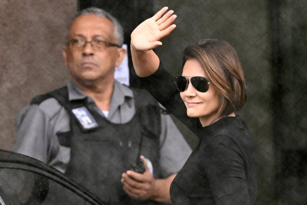 Michelle Bolsonaro, wife of Brazil’s ex-president Jair Bolsonaro, waves at supporters outside the Federal Police headquarters in Brasilia, where her husband is being held, during a visit in November. Photo: AFP Michelle Bolsonaro, wife of Brazil’s ex-president Jair Bolsonaro, waves at supporters outside the Federal Police headquarters in Brasilia, where her husband is being held, during a visit in November. Photo: AFP