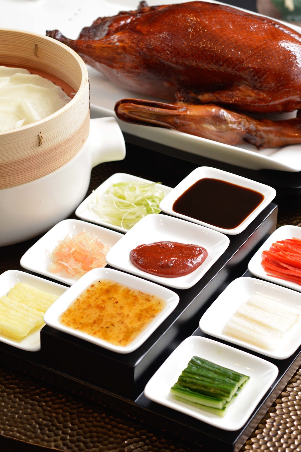 Lai Ching Heen’s Peking duck is served with pineapple and green papaya. Photo: courtesy Lai Ching Heen Lai Ching Heen’s Peking duck is served with pineapple and green papaya. Photo: courtesy Lai Ching Heen