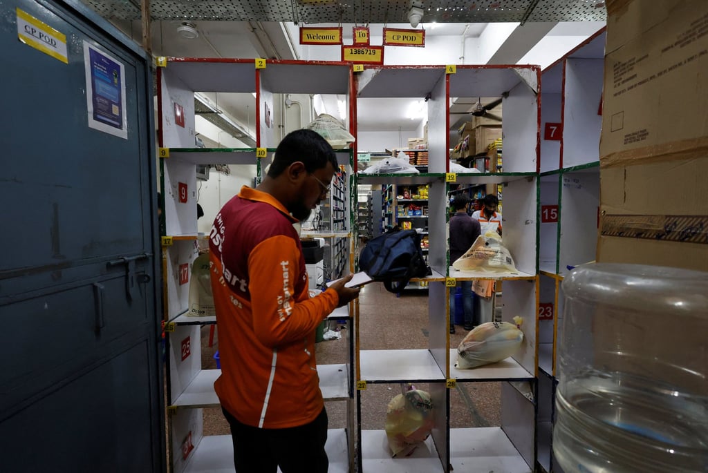 A gig worker picks up groceries for an order from a Swiggy grocery warehouse in New Delhi. A rapidly growing middle class in India has stoked demand for an array of near-instant delivery services. Photo: Reuters