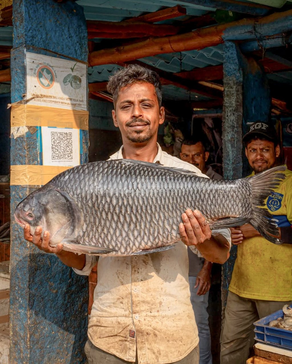 A local picks up a fish at the HAL Market, in Jyothi Nagar. Photo: Sanskriti Bist A local picks up a fish at the HAL Market, in Jyothi Nagar. Photo: Sanskriti Bist