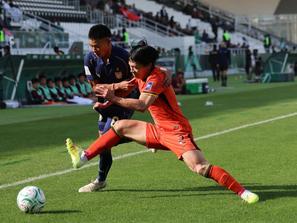 China’s under-23 team (orange) drew with Thailand 0-0 in their final group match. Photo: Xinhua