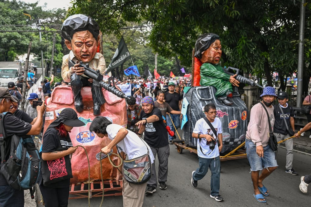 People march with effigies of Philippine President Ferdinand Marcos Jnr and Vice-President Sara Duterte during a protest in Manila last month. Photo: AFP