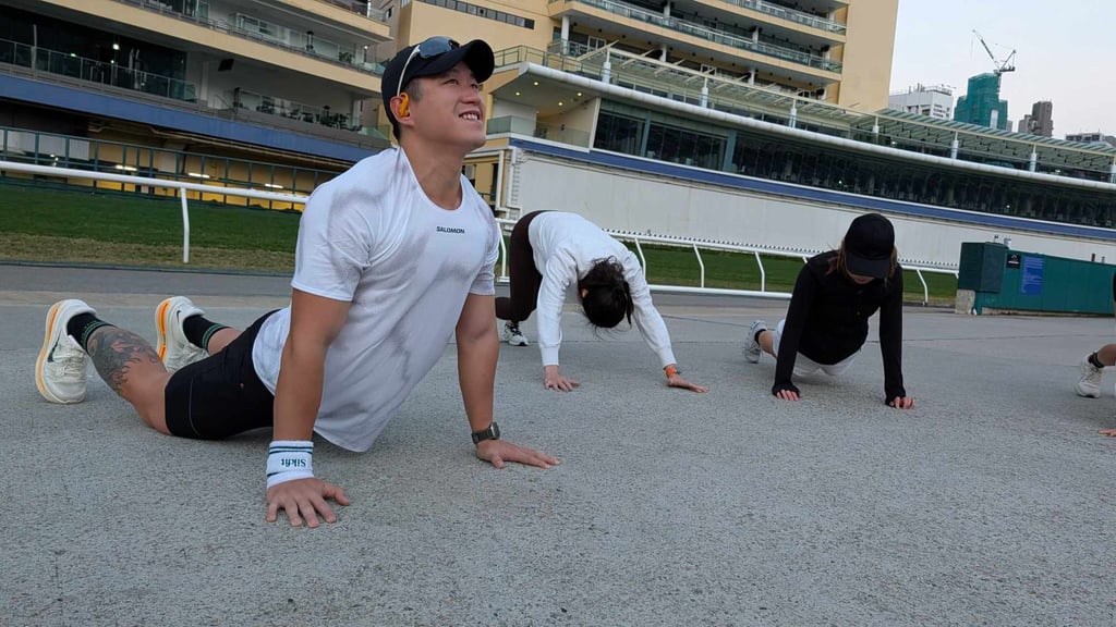 Michael Sik (left) takes his group through a warm-up before their Happy Valley run. Photo: Chieu Luu Michael Sik (left) takes his group through a warm-up before their Happy Valley run. Photo: Chieu Luu