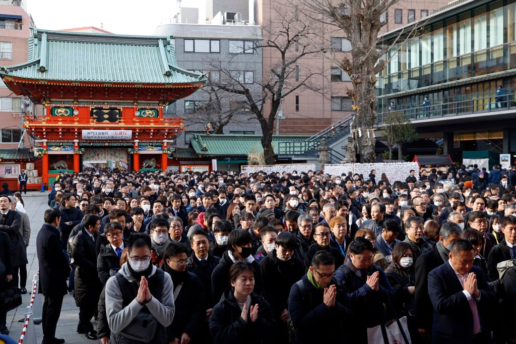 Businesspeople offer prayers for prosperity for their companies and the economy on the first business day of the year at the Kanda Myojin Shrine in Tokyo, Japan, on January 5. Photo: EPA