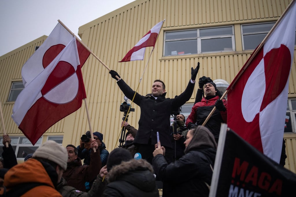 Greenland’s Prime Minister Jens-Frederik Nielsen waves Greenland’s flag during the protest on Saturday in Nuuk against US President Donald Trump’s demand that the Arctic island be ceded to the US. Photo: Reuters