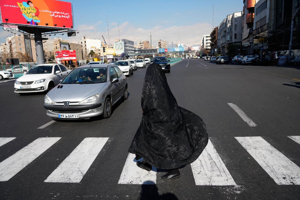 A woman crosses an intersection in downtown Tehran on Friday. Photo: AP A woman crosses an intersection in downtown Tehran on Friday. Photo: AP