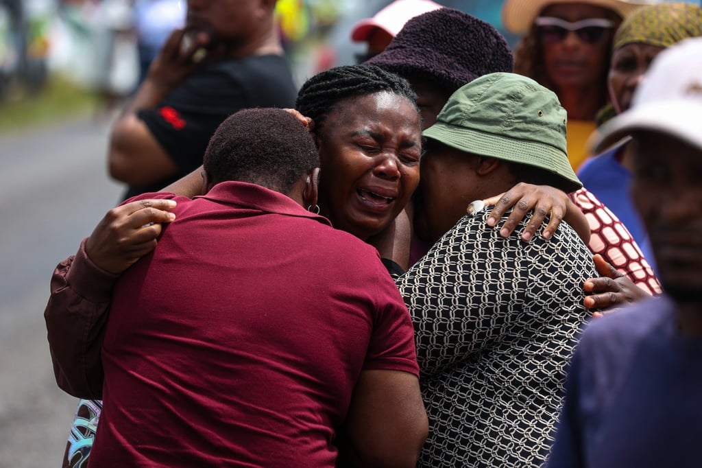 Relatives of children who died when the minibus they were riding in collided with a truck, weep at the scene of the crash on Monday. Photo: AP Relatives of children who died when the minibus they were riding in collided with a truck, weep at the scene of the crash on Monday. Photo: AP