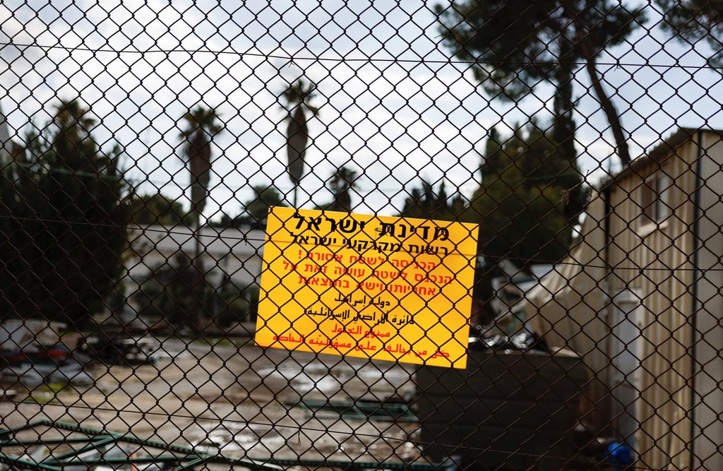 A sign warning entry is prohibited hangs on the fence of UNRWA’s East Jerusalem headquarters as Israeli forces dismantle the site on Tuesday. Photo: Reuters