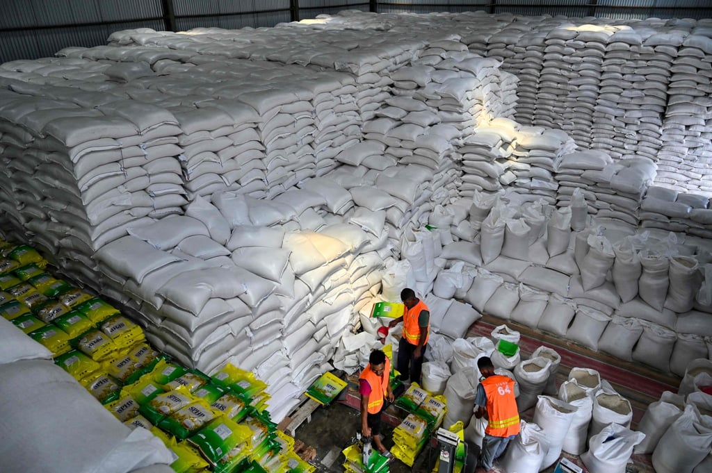 Workers sort sacks of rice at a warehouse in Aceh province. Indonesia and the US are still negotiating a trade deal that would lower the tariff rate from a threatened 32 per cent to 19 per cent. Photo: AFP