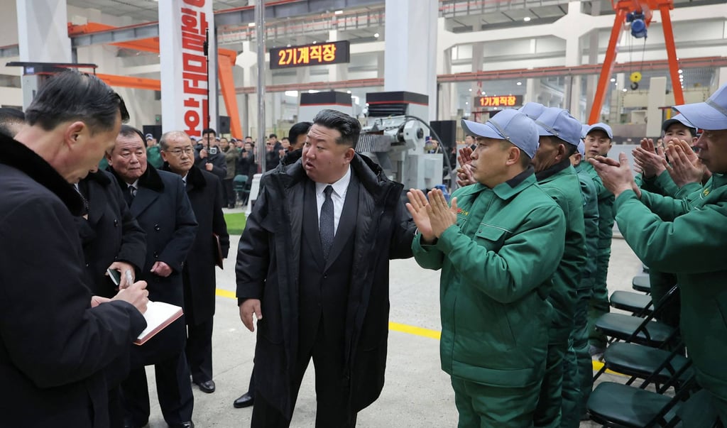 North Korean leader Kim Jong-un (centre) is applauded by workers at the Ryongsong Machine Complex during his inspection tour on Monday. Photo: KCNA/AFP