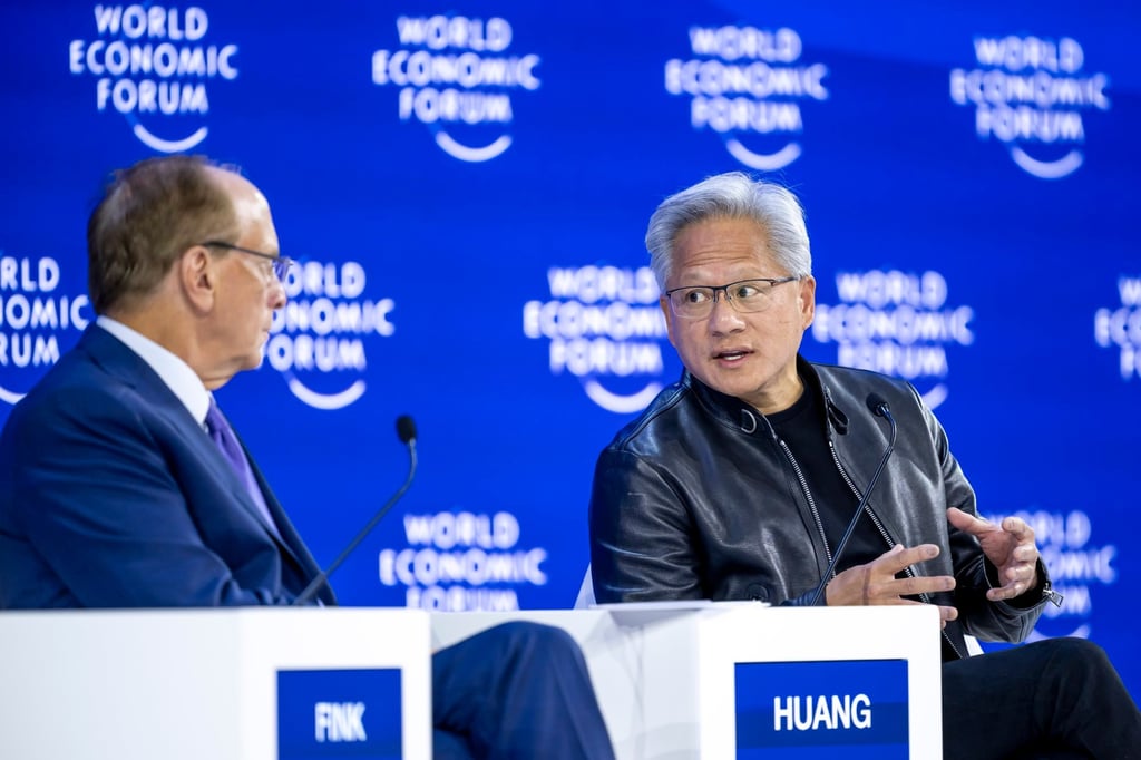 BlackRock chairman and WEF co-chairman Larry Fink (left) and Nvidia founder and CEO Jensen Huang speak during a panel discussion at the World Economic Forum in Davos, Switzerland, on Wednesday. Photo: EPA