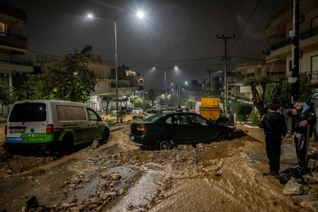 People try to clean a flooded street covered with rubble after heavy rainfall in Athens on Wednesday. Photo: AFP People try to clean a flooded street covered with rubble after heavy rainfall in Athens on Wednesday. Photo: AFP
