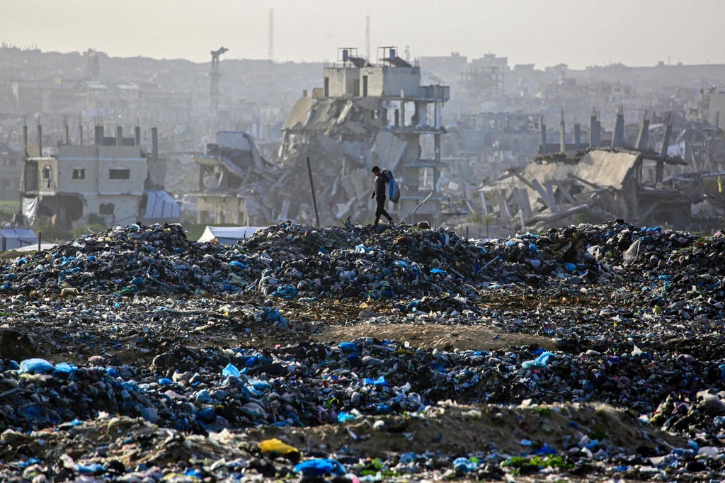 A landfill against the backdrop of destroyed buildings in Khan Younis, in the southern Gaza Strip. Photo: AFP