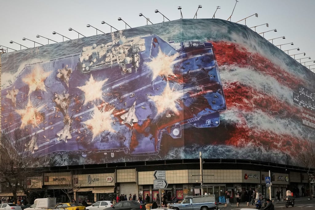 The billboard depicts a damaged US aircraft carrier with disabled fighter jets on its deck. Photo: AP The billboard depicts a damaged US aircraft carrier with disabled fighter jets on its deck. Photo: AP