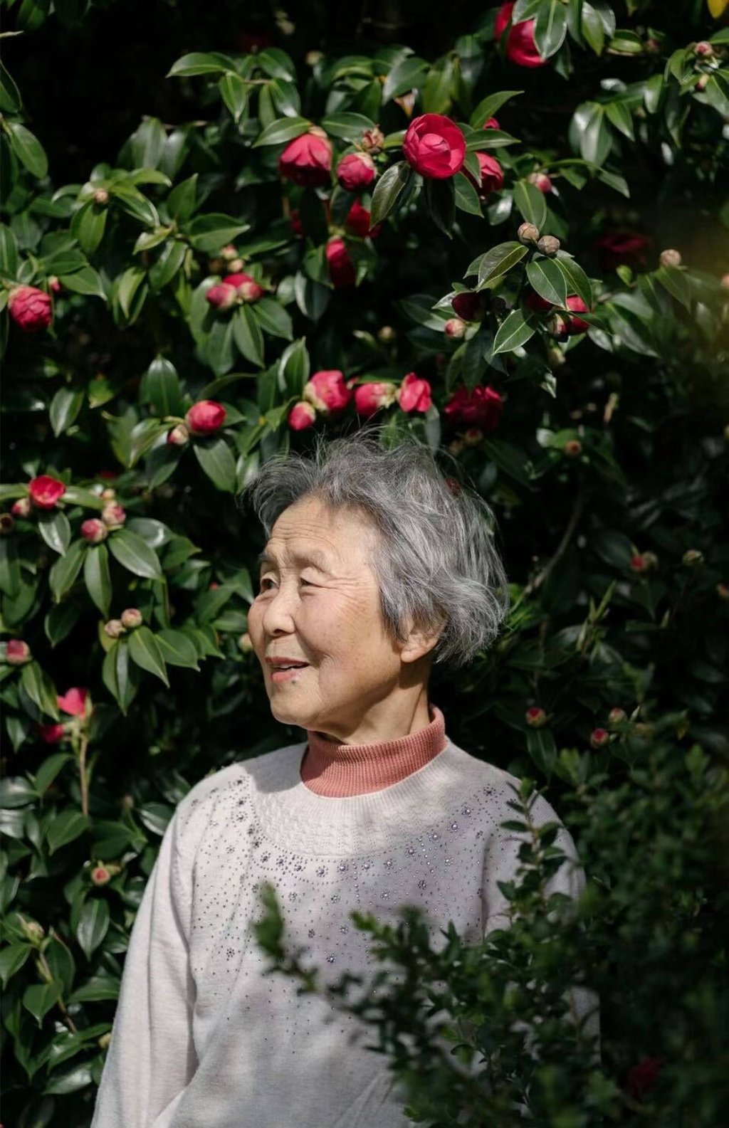 A grandmother, one of the interviewees for The Discourse, sells flowers on a footbridge, weaving stories of perseverance and everyday beauty into the vibrant tapestry of city life. Photo: Handout
