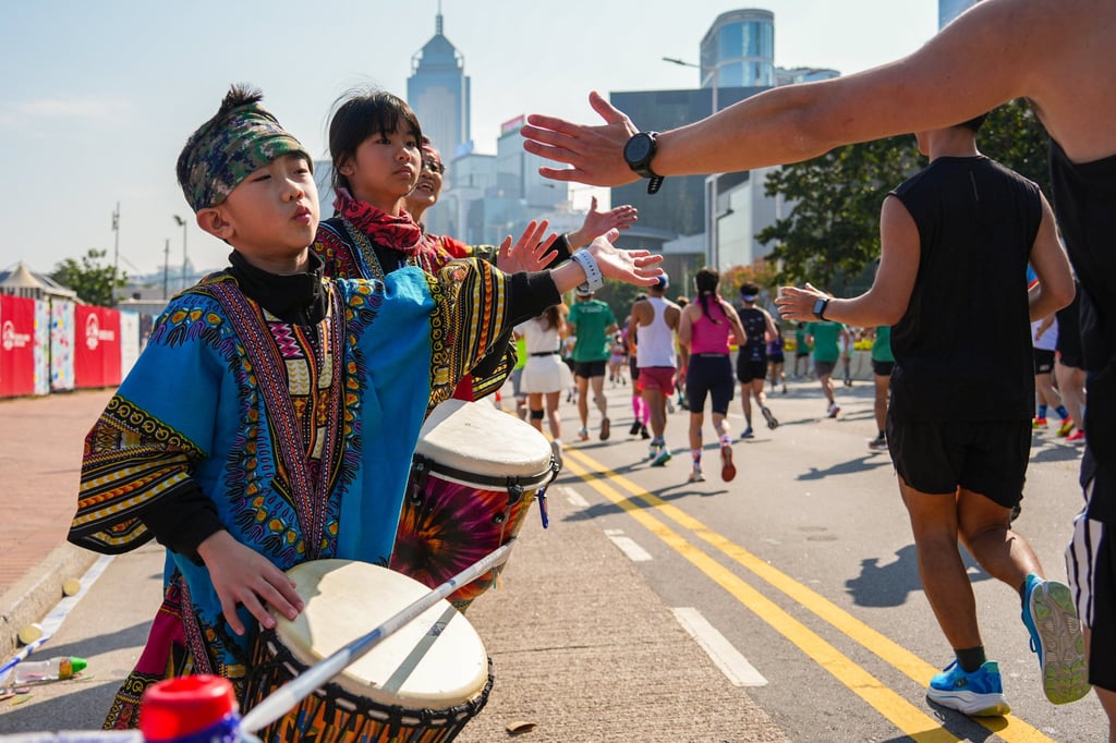 Children cheer runners during the marathon. Photo: Eugene Lee
