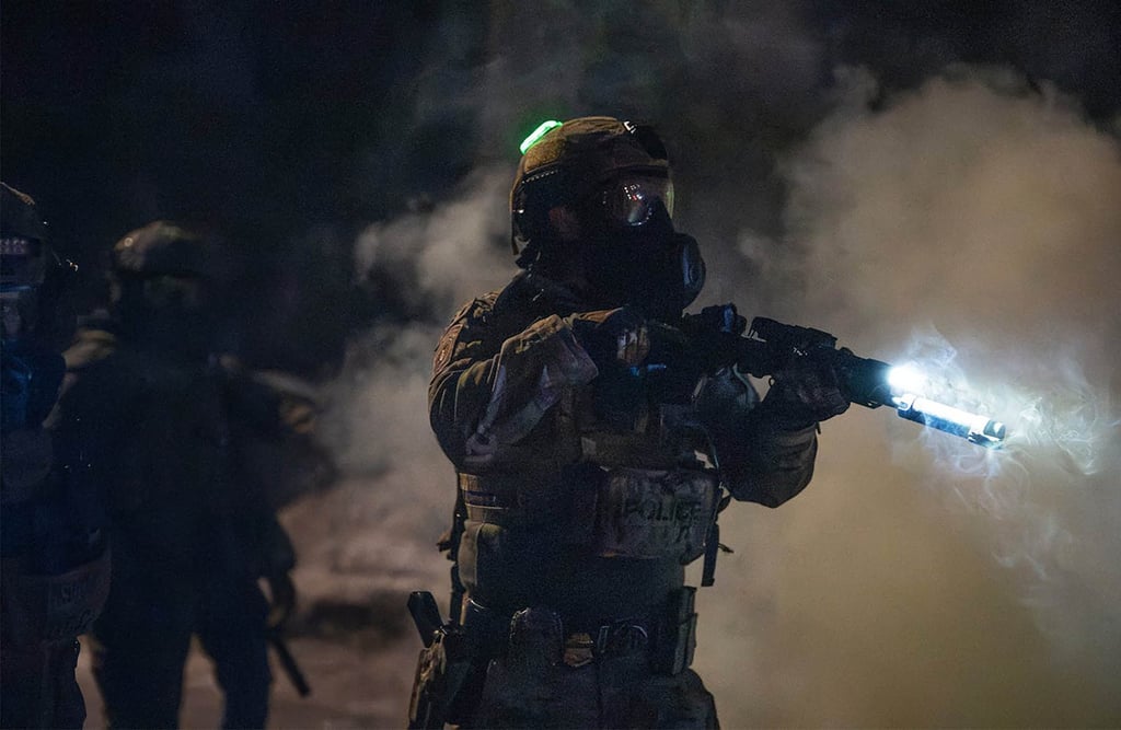 Federal agents attempt to push protesters back near the scene of a shooting by a federal agent in Minneapolis on January 14. Photo: TNS