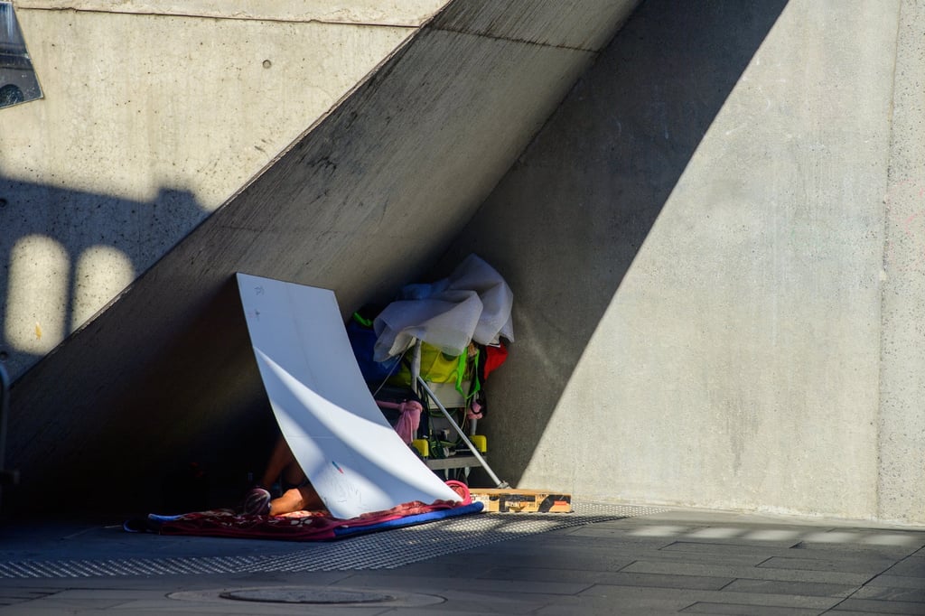 A homeless person lies under an improvised shade to escape the sun in Melbourne, Australia, on Tuesday. Photo: EPA