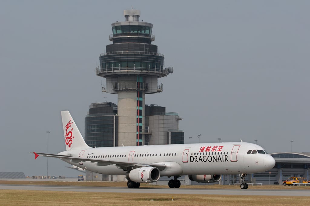 A Dragonair plane flies past the control tower at Chek Lap Kok Airport on October 17, 2004. Photo: SCMP