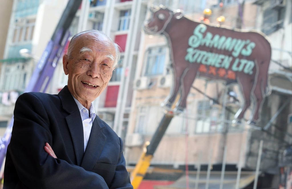 Sammy’s Kitchen founder Sammy Yip stands in front of the restaurant’s famous neon sign in 2015. Yip died in 2021. Photo: K.Y. Cheng