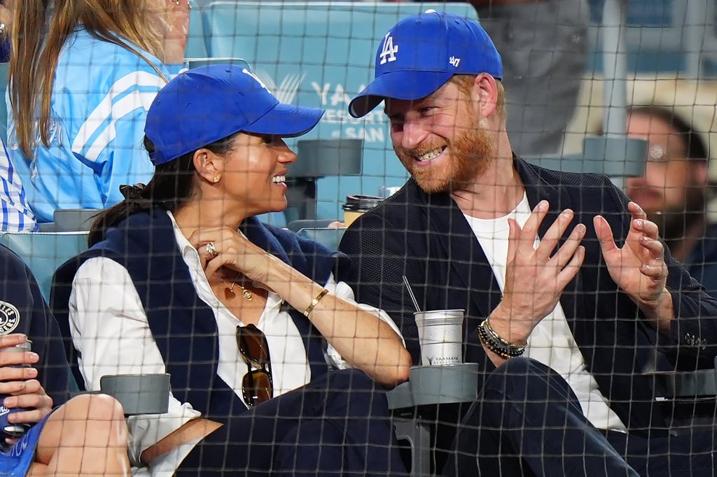 Meghan Markle wore a draped jumper for baseball’s World Series in Los Angeles in October 2025, with an LA Dodgers hat also sported by Prince Harry. Photo: AP