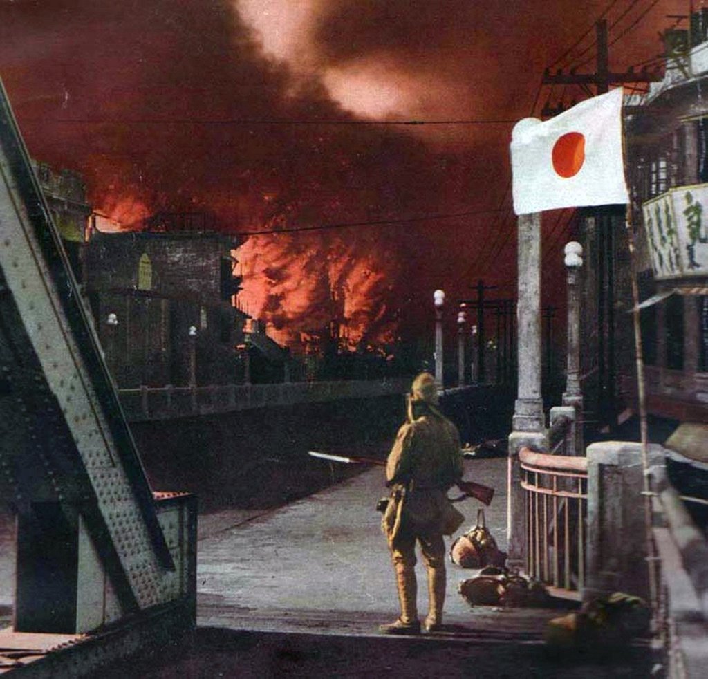 A Japanese soldier watches the suburbs of Shanghai ablaze during World War II in this undated colourised photograph. Photo: Getty Images A Japanese soldier watches the suburbs of Shanghai ablaze during World War II in this undated colourised photograph. Photo: Getty Images